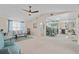 Bright living room showcasing a ceiling fan, comfortable seating, dining area and open access to the kitchen at 3158 Pebble Bend Dr, Lakeland, FL 33810