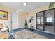 Enclosed sunroom with exercise equipment, neutral decor, a ceiling fan, and sliding glass doors to another living space at 3158 Pebble Bend Dr, Lakeland, FL 33810