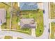 Aerial view of a home with green grass, a fence and a driveway at 3510 Kenwood Xing, Lakeland, FL 33812