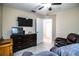 Bedroom with a TV, dresser, and view into an adjacent room at 3510 Kenwood Xing, Lakeland, FL 33812