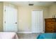 Bright bedroom featuring tile floors, closet and dresser with neutral colored walls at 3510 Kenwood Xing, Lakeland, FL 33812