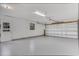 Garage featuring an epoxy floor, electric door, and peg board walls at 3511 Southcrest Blvd, Lakeland, FL 33812