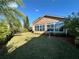 Backyard with well manicured lawn and sun room at 394 Nolane Ln, Polk City, FL 33868