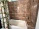 Tiled bathtub and shower with tropical leaf curtain in bathroom at 394 Nolane Ln, Polk City, FL 33868