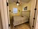 Bedroom with a ceiling fan, window and palm tree decorations at 394 Nolane Ln, Polk City, FL 33868