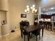 Dining room view featuring modern chandelier, table and chairs, and easy access to the kitchen at 394 Nolane Ln, Polk City, FL 33868