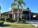Beautiful front exterior of a house with a lush green lawn and a majestic palm tree, adding a touch of tropical elegance at 394 Nolane Ln, Polk City, FL 33868