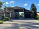 Charming home featuring a connected garage, paver driveway, and a well-maintained lawn, all under a sunny sky at 394 Nolane Ln, Polk City, FL 33868