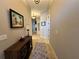 Neutral-toned hallway featuring decorative accents, tiled flooring, and inviting lighting fixtures for a warm ambiance at 394 Nolane Ln, Polk City, FL 33868