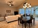 Living room with stylish furnishings, vaulted ceiling and access to the lanai at 394 Nolane Ln, Polk City, FL 33868