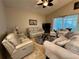 Comfortable living room with plush seating, a ceiling fan, and sliding glass doors leading to an outdoor area at 394 Nolane Ln, Polk City, FL 33868