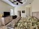 Bright and spacious main bedroom features a ceiling fan and ample closet space at 394 Nolane Ln, Polk City, FL 33868