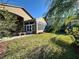 Backyard sun room with windows overlooking a well manicured lawn at 394 Nolane Ln, Polk City, FL 33868