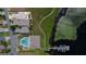 Aerial view showcasing community pool, clubhouse, boat dock, and scenic walking trail along the lake at 3976 Cypress W Lndg, Winter Haven, FL 33884