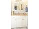 Bathroom with white vanity, framed mirror, neutral countertops, and decorative accents at 3976 Cypress W Lndg, Winter Haven, FL 33884