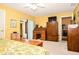 Spacious primary bedroom featuring an wooden desk, TV, and sliding glass door, offering ample space and natural light at 3976 Cypress W Lndg, Winter Haven, FL 33884