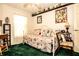 Cozy bedroom featuring daybed with decorative pillows, green carpet, and charming decor at 3976 Cypress W Lndg, Winter Haven, FL 33884
