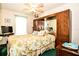 Inviting bedroom featuring a decorative bed, a large mirror and a view of the window at 3976 Cypress W Lndg, Winter Haven, FL 33884