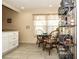 Cozy breakfast nook with a glass table and open shelving for storage at 3976 Cypress W Lndg, Winter Haven, FL 33884