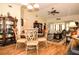 Dining area showcasing a glass table, elegant chairs, and views into the living room at 3976 Cypress W Lndg, Winter Haven, FL 33884