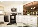 Bright, updated kitchen with stainless steel appliances, white cabinets and granite countertops at 3976 Cypress W Lndg, Winter Haven, FL 33884