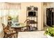 Charming kitchen nook with a glass table, TV and backyard view at 3976 Cypress W Lndg, Winter Haven, FL 33884