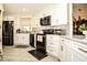 Modern kitchen featuring sleek black appliances, white cabinetry, and stylish backsplash at 3976 Cypress W Lndg, Winter Haven, FL 33884