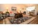Comfortable living room featuring a soft sofa, a dark wood coffee table, and an area rug at 3976 Cypress W Lndg, Winter Haven, FL 33884