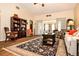 Bright living room featuring a decorative rug, bookshelves, and comfortable seating at 3976 Cypress W Lndg, Winter Haven, FL 33884