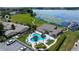 Community pool and lakefront clubhouse with lounge chairs, perfect for relaxation and enjoying the beautiful water view at 3976 Cypress W Lndg, Winter Haven, FL 33884