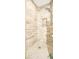 Walk-in shower featuring beautiful stone style tile, built in shelving, and updated shower head at 3976 Cypress W Lndg, Winter Haven, FL 33884