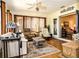 Bright and airy sunroom with tile flooring, ceiling fan, and cozy seating area at 3976 Cypress W Lndg, Winter Haven, FL 33884