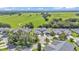 Aerial view of a residential community with manicured green spaces in a lush green environment at 42 Enclave Dr, Winter Haven, FL 33884