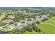 Aerial view of a residential community with manicured green spaces bordering a golf course at 42 Enclave Dr, Winter Haven, FL 33884