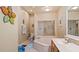 Bright bathroom featuring a soaking tub, glass shower, and vanity with modern fixtures at 42 Enclave Dr, Winter Haven, FL 33884