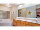 Bathroom featuring double sinks, garden tub, and window for ample natural light at 42 Enclave Dr, Winter Haven, FL 33884