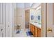 Bathroom featuring double vanity with wood cabinets, mirror, and enclosed shower stall at 42 Enclave Dr, Winter Haven, FL 33884
