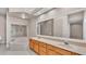 A dual sink bathroom features a large mirror and bright lighting at 42 Enclave Dr, Winter Haven, FL 33884