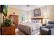 Comfortable bedroom with neutral tones, furnishings, and ample natural light from the window at 42 Enclave Dr, Winter Haven, FL 33884