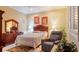 Comfortable bedroom with neutral tones, furnishings, and ample natural light from the window at 42 Enclave Dr, Winter Haven, FL 33884