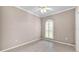This neutral bedroom has a ceiling fan and tile flooring at 42 Enclave Dr, Winter Haven, FL 33884
