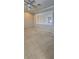 A bright bedroom featuring neutral carpet, shuttered windows, neutral walls, and a ceiling fan at 42 Enclave Dr, Winter Haven, FL 33884