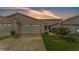 Townhome exterior with a well manicured lawn and a driveway to the attached one car garage at 42 Enclave Dr, Winter Haven, FL 33884