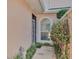 Charming front entrance with an arched window framed by green plants at 42 Enclave Dr, Winter Haven, FL 33884