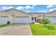 Charming townhome features a well-maintained lawn and a two-car garage at 42 Enclave Dr, Winter Haven, FL 33884