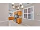 Kitchen featuring stainless steel appliances and tile backsplash with wooden cabinets and tiled floors at 42 Enclave Dr, Winter Haven, FL 33884