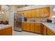 Kitchen featuring stainless steel refrigerator and wood cabinets with ample counter space at 42 Enclave Dr, Winter Haven, FL 33884