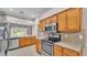 Bright kitchen features stainless appliances, tile flooring and modern lighting fixtures at 42 Enclave Dr, Winter Haven, FL 33884