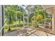 An enclosed lanai with brick floors opens to green outdoor space at 42 Enclave Dr, Winter Haven, FL 33884