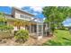 A large lanai is surrounded by mature trees and landscaping at 42 Enclave Dr, Winter Haven, FL 33884